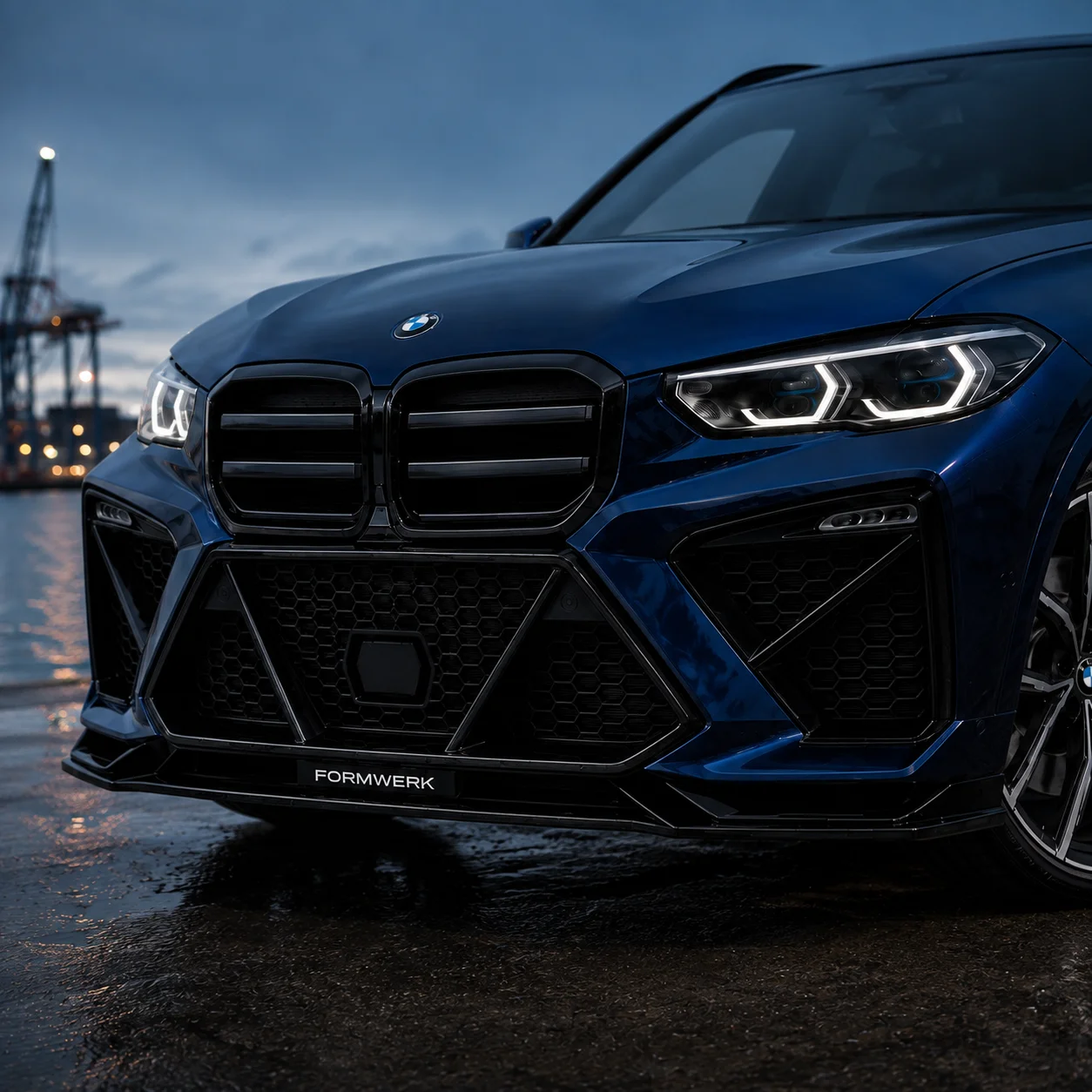 a blue X5 with the Bulldog front, head-on at the harbour.