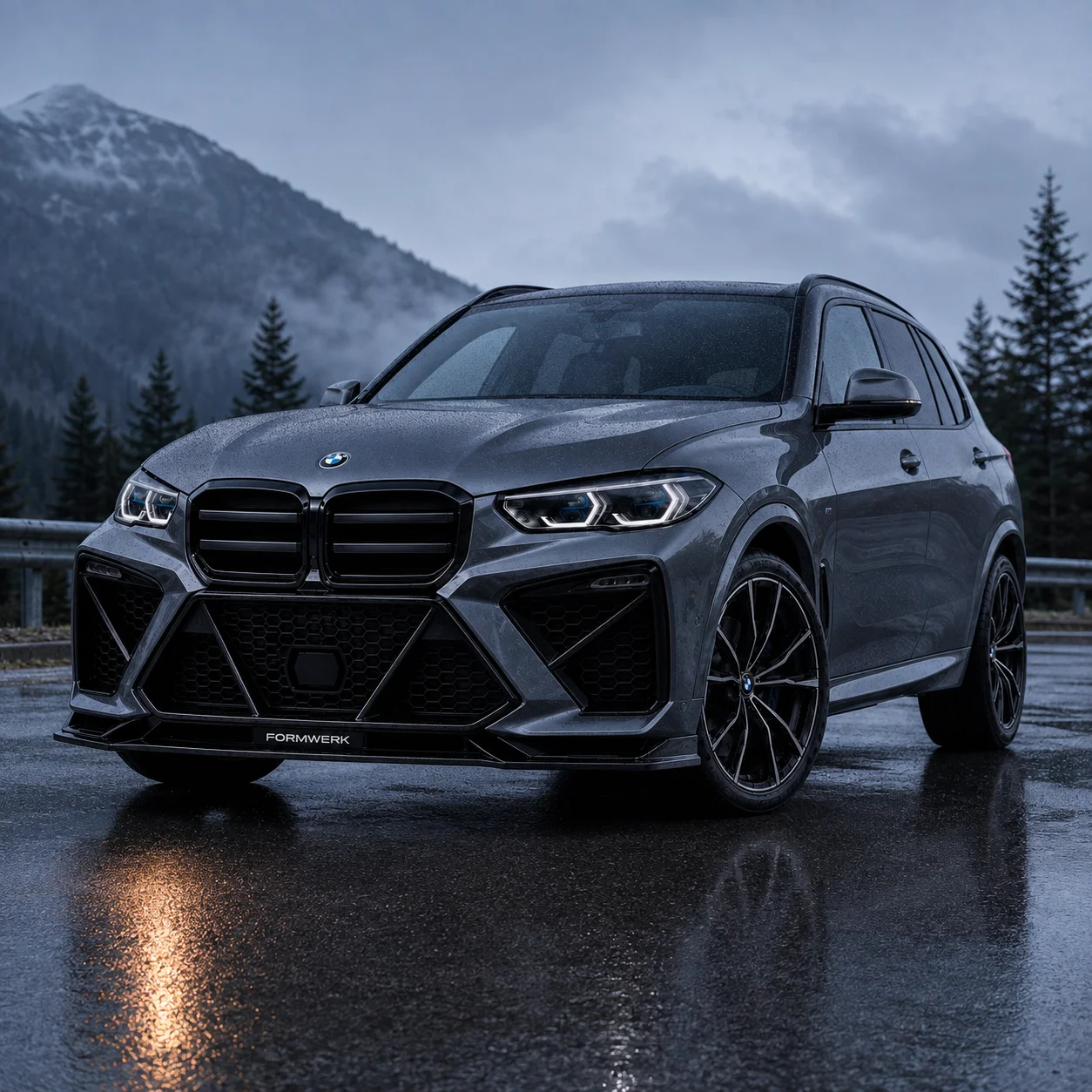 A grey X5 with the Bulldog front on a mountain road.