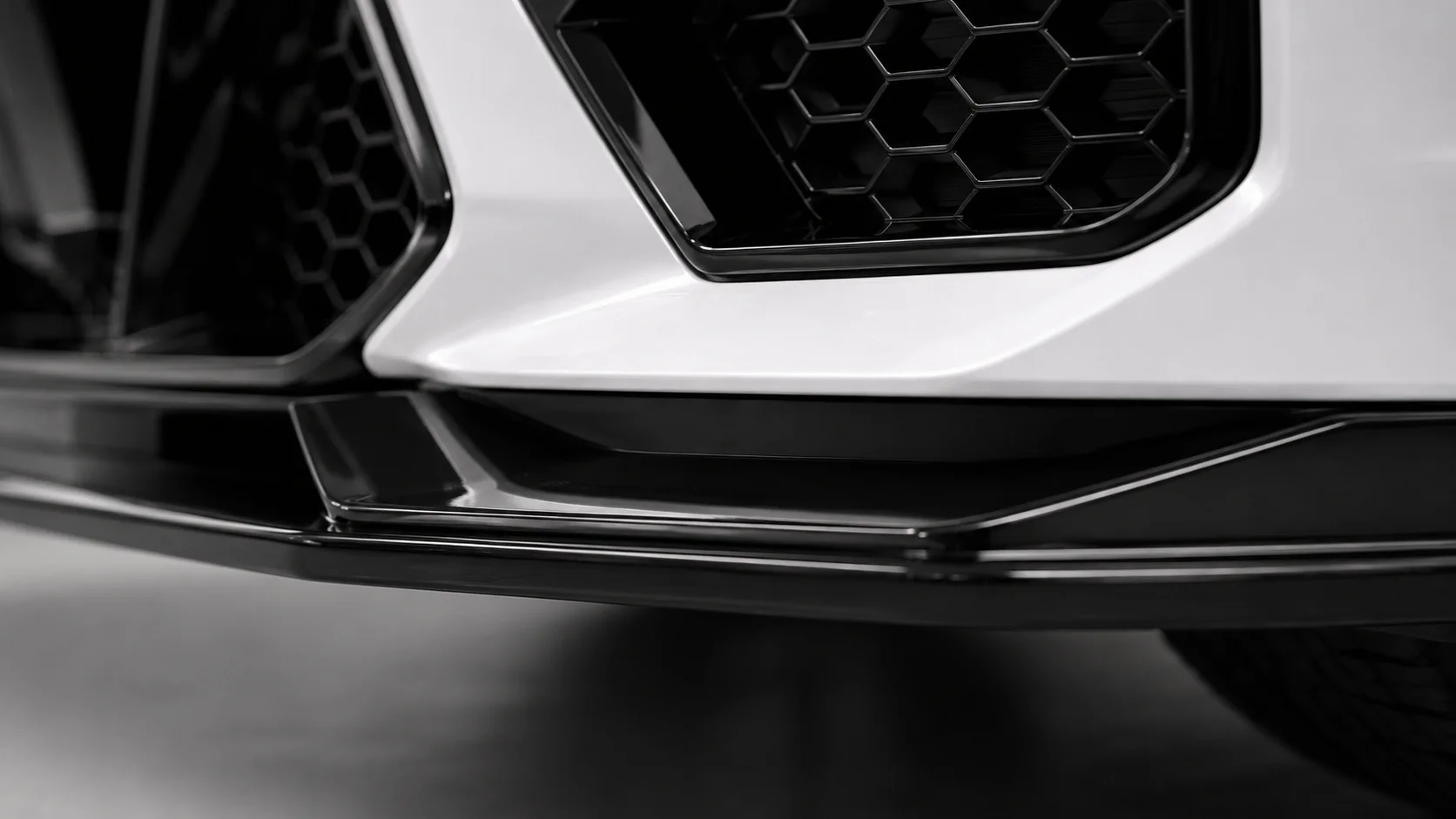 the front lip on the car, low and close, showing the gap to the bumper.